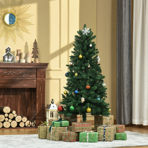 Abeto de Navidad artificial decorado con bolas junto a una chimenea y regalos