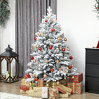 Árbol de Navidad nevado decorado con bolas y regalos