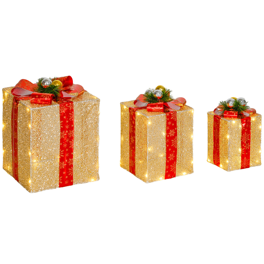Set de 3 cajas de regalo doradas con lazo rojo y luces LED, de tres tamaños, sobre fondo blanco