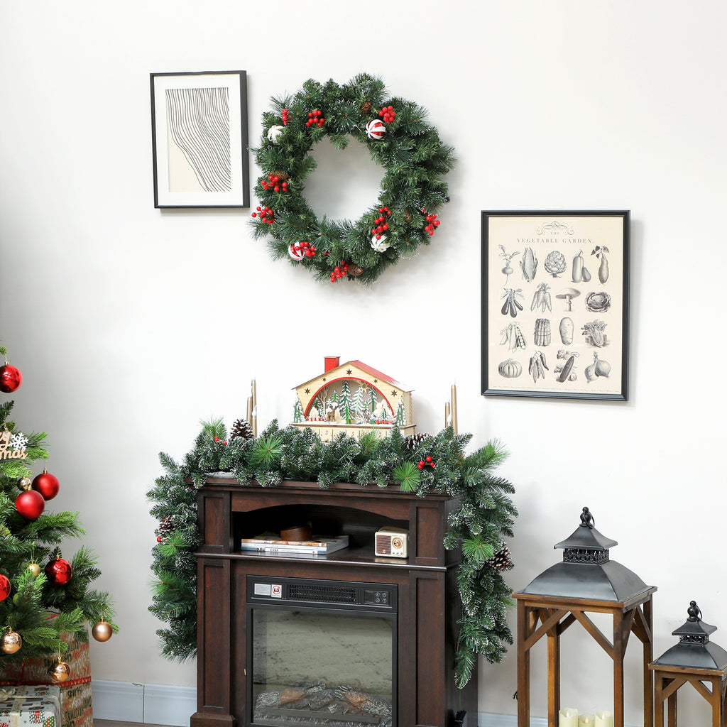 Corona de Navidad con luces cálidas en una pared blanca junto a un cuadro y una cómoda