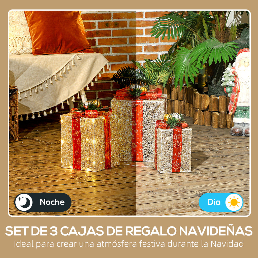 Set de 3 cajas de regalo navideñas con luz de noche y de día en un porche