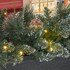 Detalle de las ramas de la guirnalda con piñas y luces LED sobre una consola