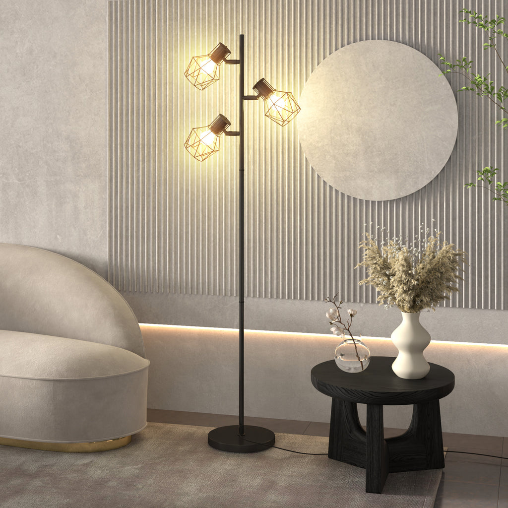 Lámpara de pie en forma de árbol encendida junto a un sofá y una mesa auxiliar