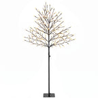Árbol de cerezo luminoso con luz blanca cálida y base negra sobre fondo blanco