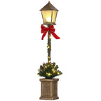 Farol de Navidad LED con lazo rojo y árbol verde iluminado sobre fondo blanco