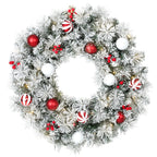 Corona de Navidad nevada de 60 cm con bolas rojas y blancas, bastones de caramelo y bayas, vista frontal sobre fondo blanco
