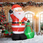 Papá Noel hinchable de 180 cm junto a una casa de ladrillo decorada para Navidad